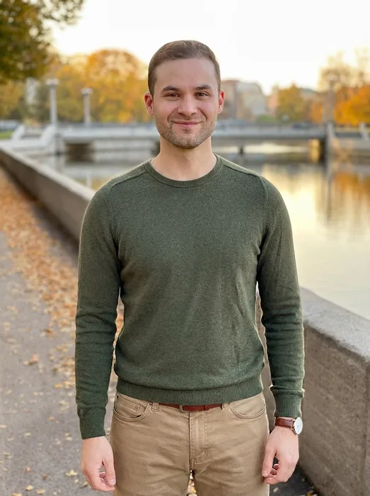 Joshua McSorley portrait, outdoors in a green sweater